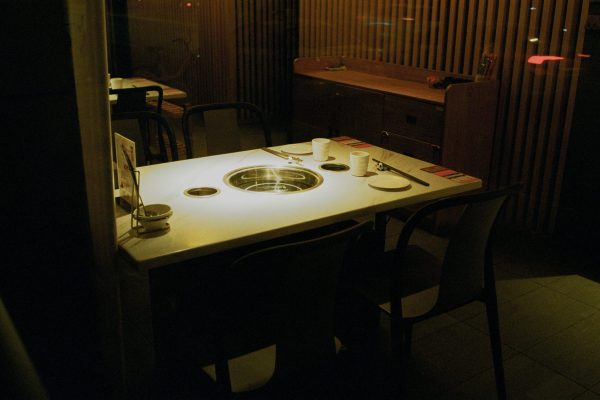 Warm, dimly lit restaurant setting featuring a grill table ready for dining.