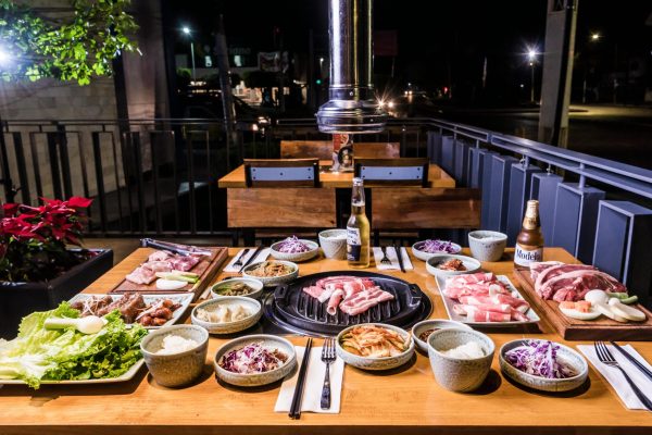 Delicious Korean BBQ spread with meats and vegetables. Perfect for dining enthusiasts.